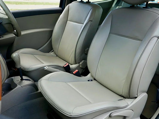 Clean gray leather car seats with visible stitching detail, front interior view 