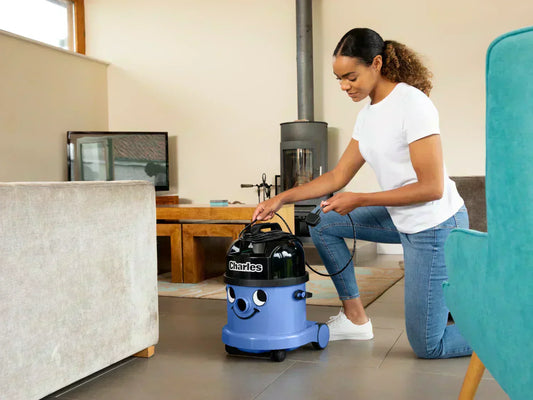 A woman winds the cord around Charles vacuum 