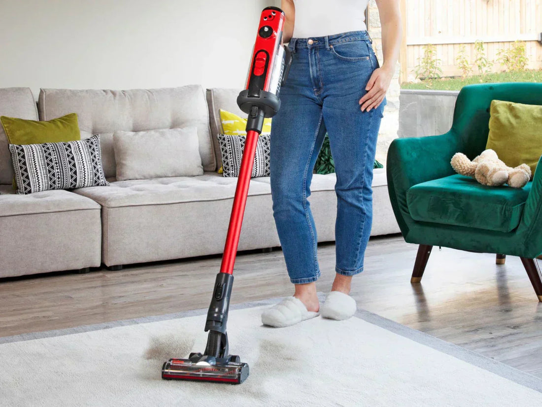Woman using a stick vacuum to clean